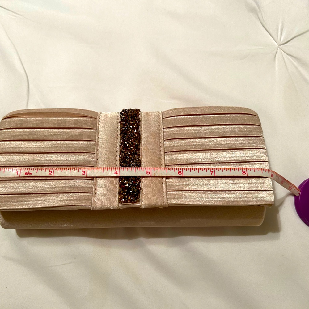 Gold satin clutch purse with shiny embellishments.